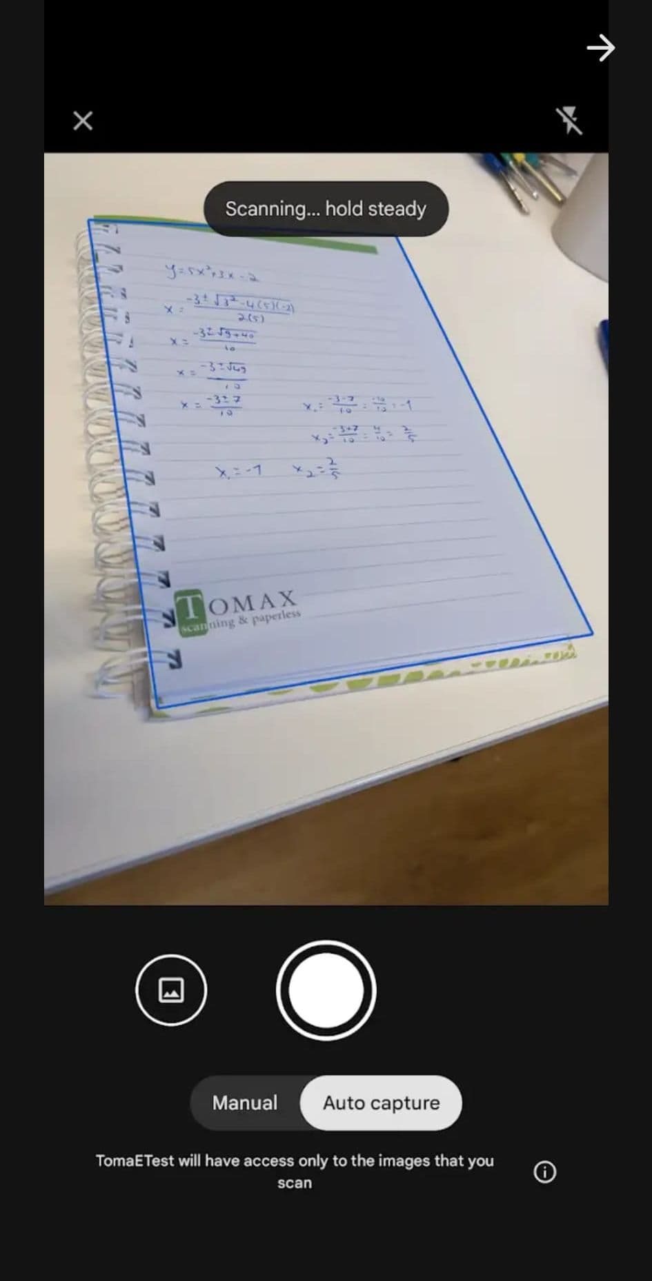 Tomax App camera view scanning a handwritten answer sheet